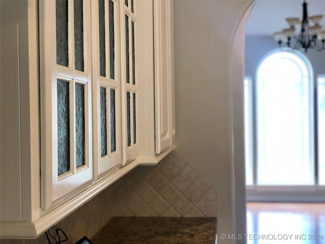 interior details featuring an inviting chandelier