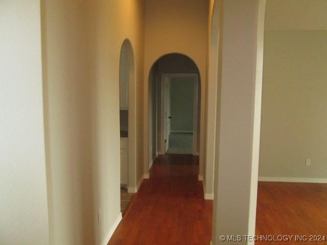 corridor featuring dark wood-type flooring