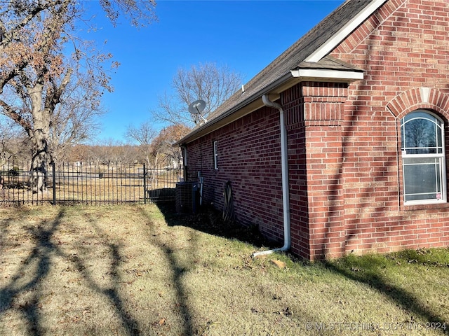 view of side of home featuring a lawn