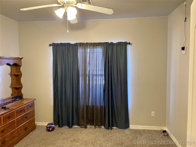 unfurnished bedroom featuring ceiling fan and light colored carpet