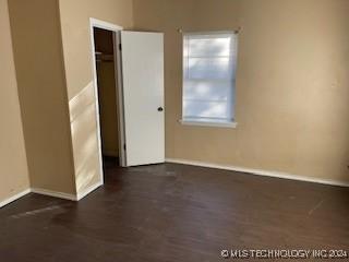 spare room with dark hardwood / wood-style flooring