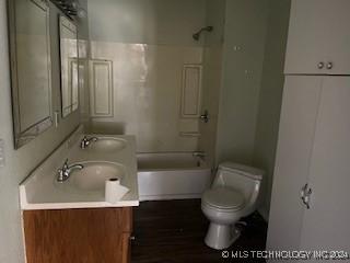 full bathroom featuring vanity, shower / bathtub combination, and toilet