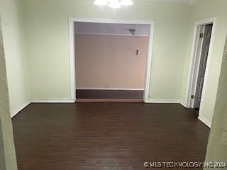 unfurnished room with dark hardwood / wood-style flooring