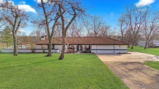 view of front of property with a garage and a front yard