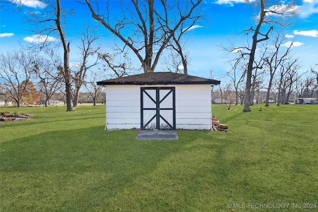 view of outdoor structure featuring a lawn