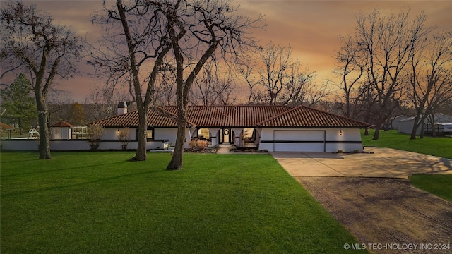 view of front of property featuring a garage and a yard