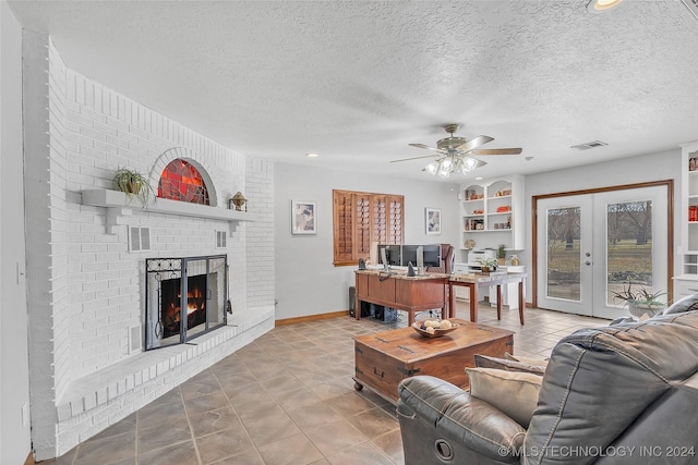 living room with a fireplace, french doors, a textured ceiling, and ceiling fan