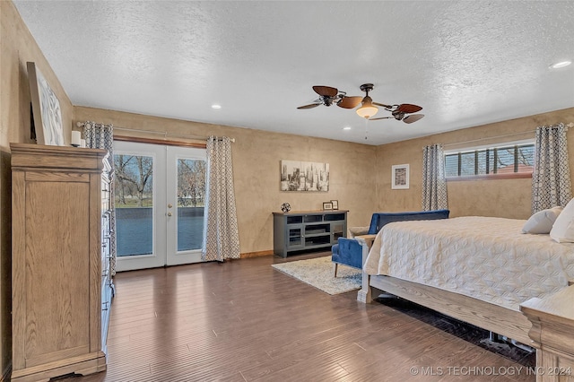 bedroom with ceiling fan, dark wood-type flooring, multiple windows, and french doors