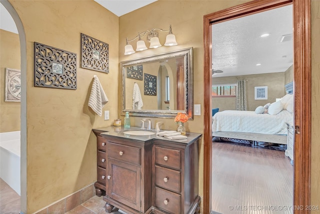 bathroom with a textured ceiling and vanity