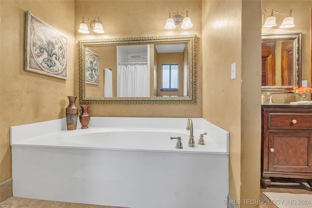 bathroom featuring a tub to relax in and vanity