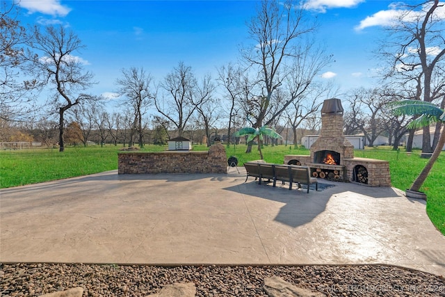 view of patio featuring an outdoor stone fireplace