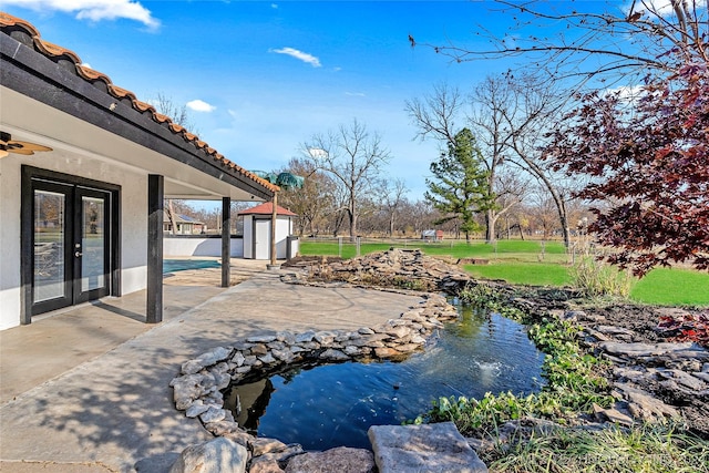 exterior space with a shed, a patio, and french doors