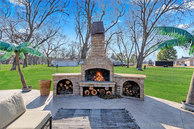 view of patio featuring an outdoor stone fireplace