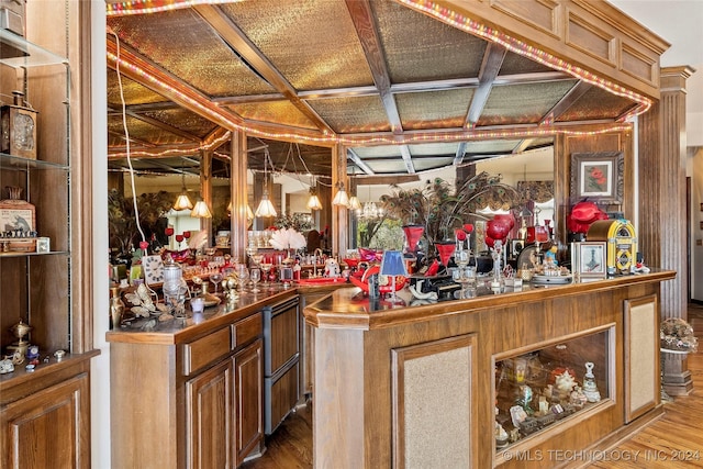 bar featuring light hardwood / wood-style floors and coffered ceiling