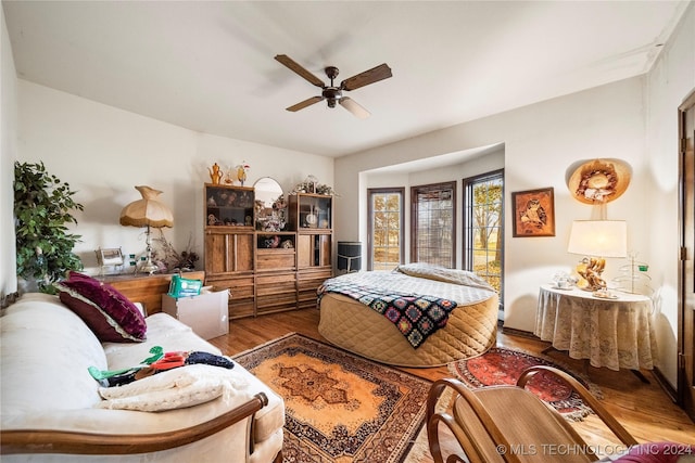 bedroom with ceiling fan and wood-type flooring