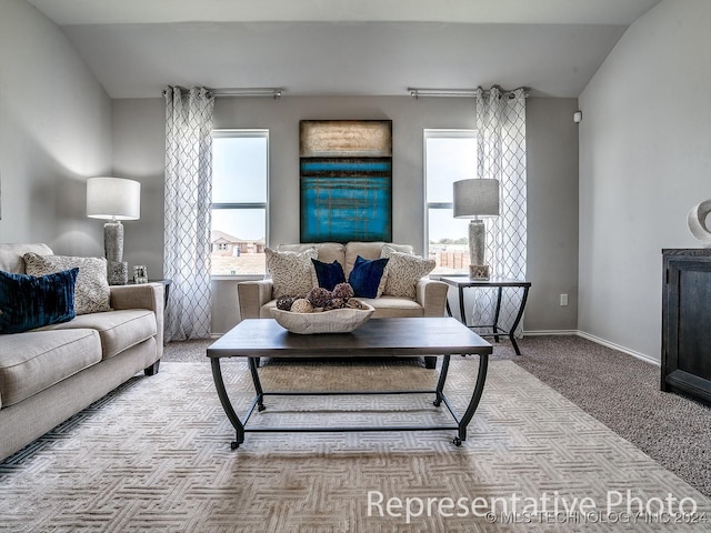 living room featuring light carpet, plenty of natural light, and lofted ceiling