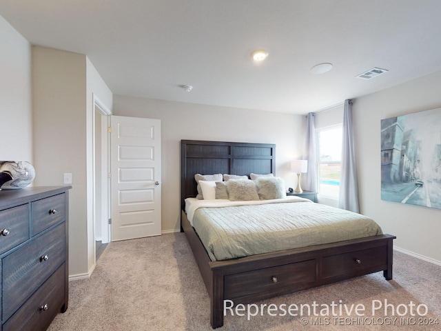 bedroom with light colored carpet