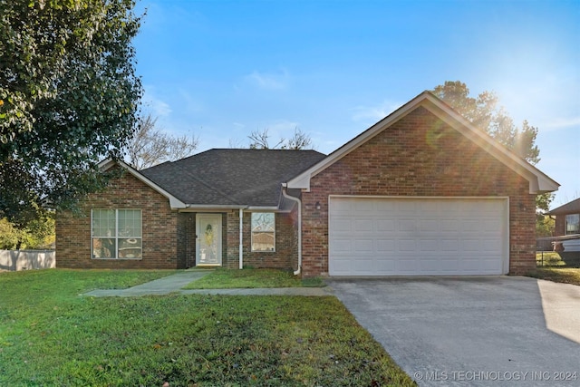 view of front facade featuring a front yard and a garage