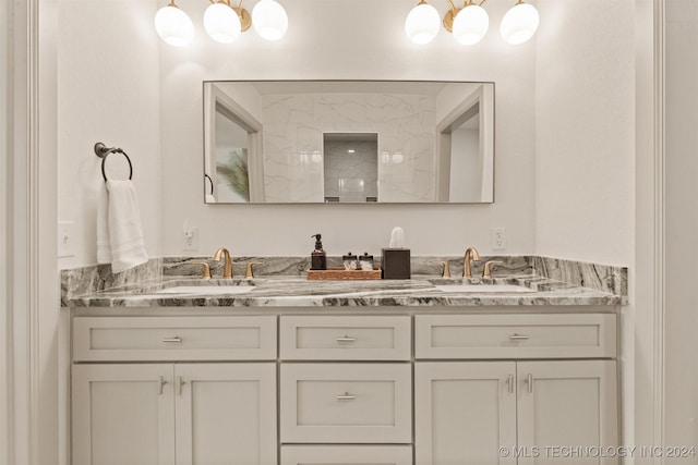 bathroom featuring vanity, walk in shower, and a chandelier