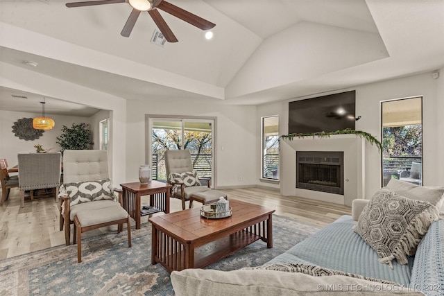 living room with hardwood / wood-style floors, vaulted ceiling, and ceiling fan