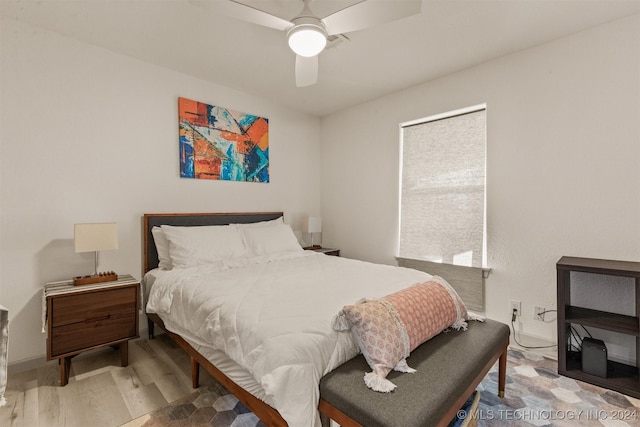 bedroom with ceiling fan and hardwood / wood-style flooring