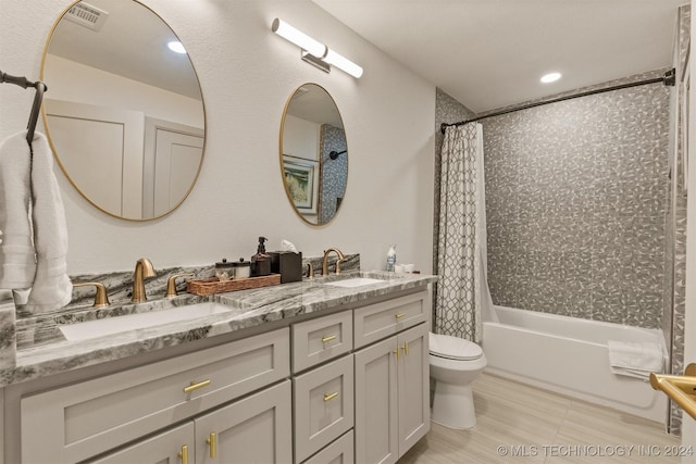 full bathroom featuring vanity, toilet, and shower / bath combo with shower curtain