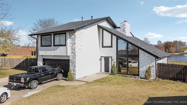 exterior space with a yard and a garage