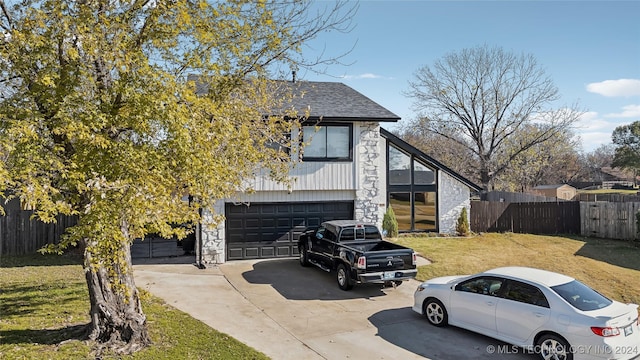 view of front of property with a garage and a front lawn