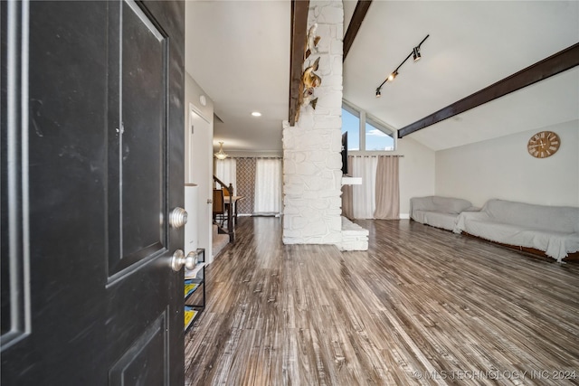 foyer featuring dark hardwood / wood-style flooring, lofted ceiling with beams, and track lighting