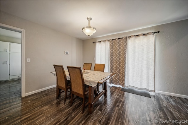 dining area with dark wood-type flooring