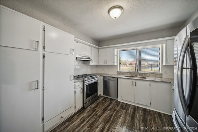 kitchen with white cabinets, sink, decorative backsplash, dark hardwood / wood-style flooring, and stainless steel appliances