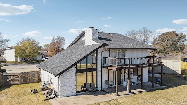 rear view of house featuring a deck, a yard, and a patio