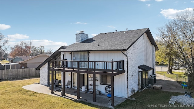 back of house with a yard, a patio, and a wooden deck