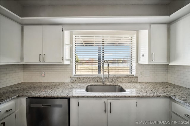 kitchen with dishwasher, white cabinetry, and sink