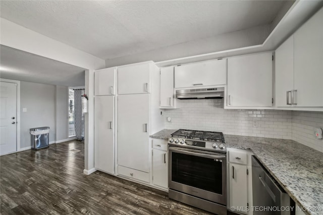 kitchen with light stone countertops, dark hardwood / wood-style flooring, stainless steel appliances, and white cabinetry