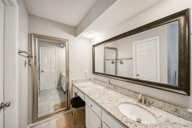 bathroom featuring tile patterned flooring and vanity