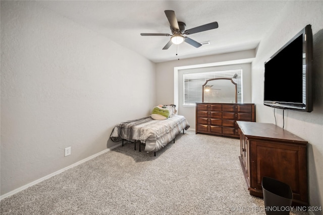 bedroom featuring light carpet and ceiling fan