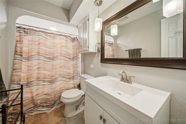 bathroom featuring tile patterned flooring, vanity, and toilet