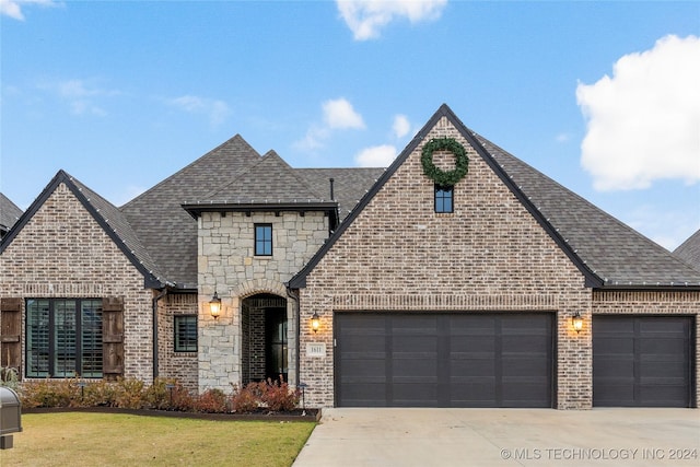 view of front of home with a garage and a front lawn