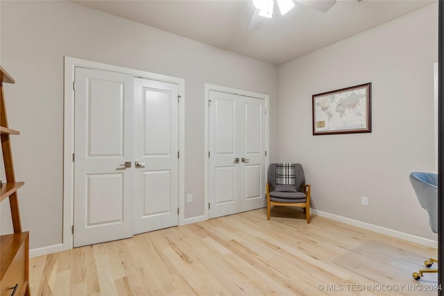 living area featuring ceiling fan and light hardwood / wood-style floors