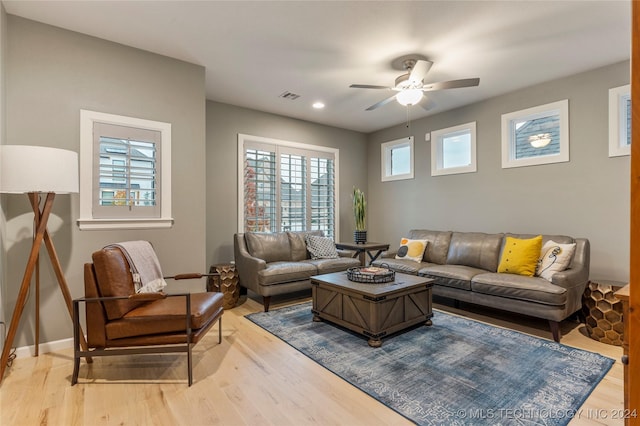 living room with ceiling fan and hardwood / wood-style flooring