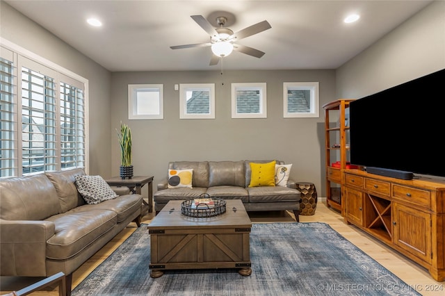 living room featuring ceiling fan and light hardwood / wood-style floors