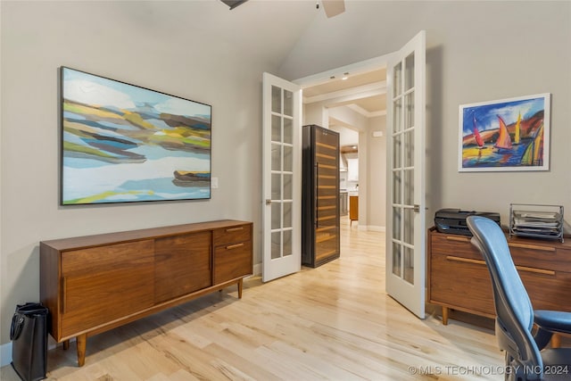 office featuring ceiling fan, vaulted ceiling, light hardwood / wood-style flooring, and french doors