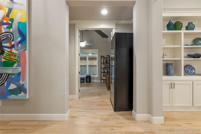 corridor with light hardwood / wood-style flooring