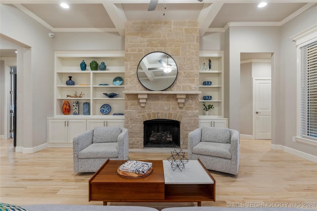 living room with beam ceiling, ceiling fan, light hardwood / wood-style flooring, a fireplace, and ornamental molding