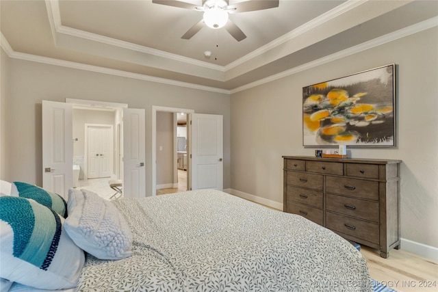 bedroom with a raised ceiling, ceiling fan, light wood-type flooring, and ornamental molding