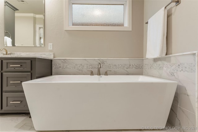 bathroom featuring vanity, tile walls, and a tub