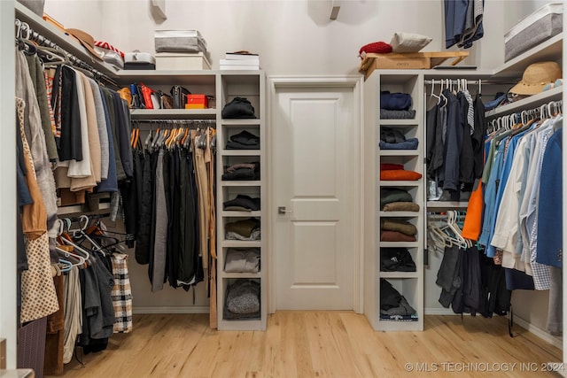 spacious closet with light hardwood / wood-style floors