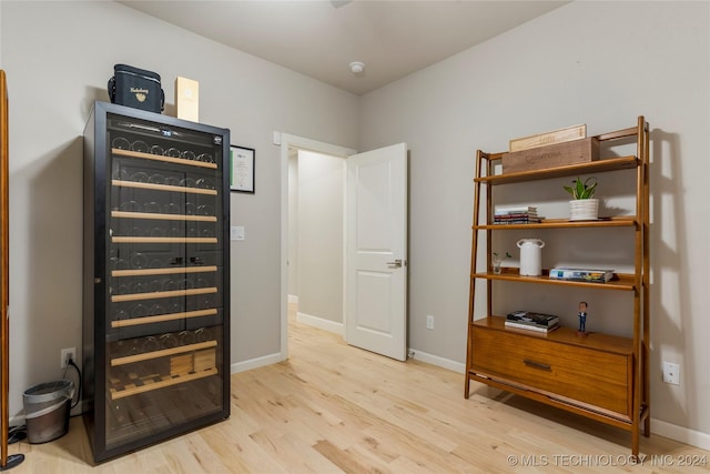 interior space with light wood-type flooring and wine cooler