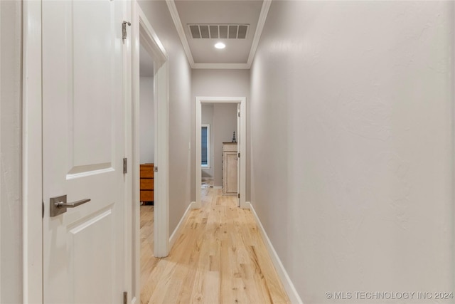 corridor with crown molding and light wood-type flooring